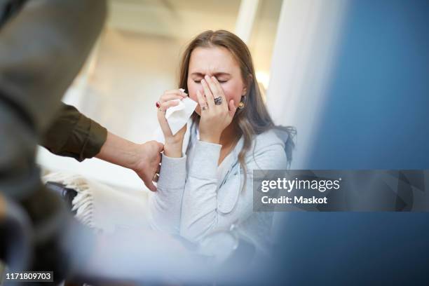 female doctor consoling sad patient at therapy office - woman crying stock pictures, royalty-free photos & images