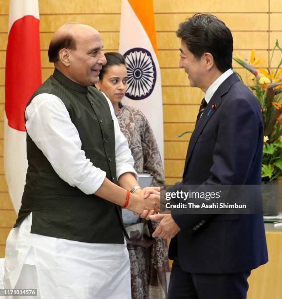 Indian Defense Minister Rajnath Singh and Japanese Prime Minister Shinzo Abe shake hands prior to their meeting at the prime minister's official...