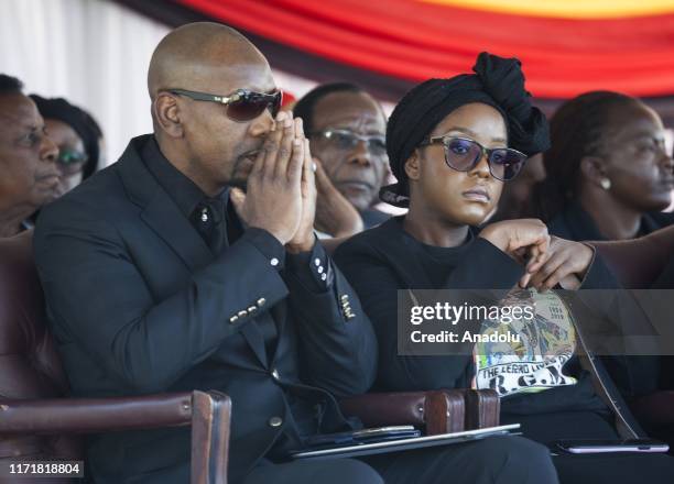 Late and former Zimbabwean president Robert Mugabe's daughter Bona Mugabe and his spouse Simba Chikore watch as the coffin of Mugabe is ready to be...