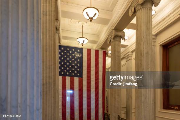 a us flag hanging at the corridor ceiling of us capitol corridor ceiling, interior, washington dc - congress interior stock pictures, royalty-free photos & images