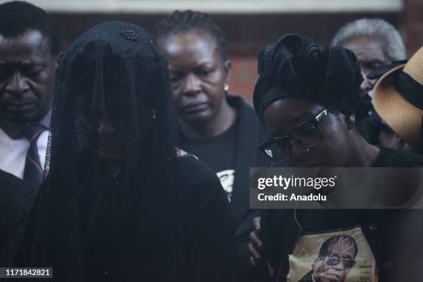 Late and former Zimbabwean president Robert Mugabe's wife Grace Mugabe and his daughter Bona Mugabe are seen during the burial of Mugabe in Harare,...