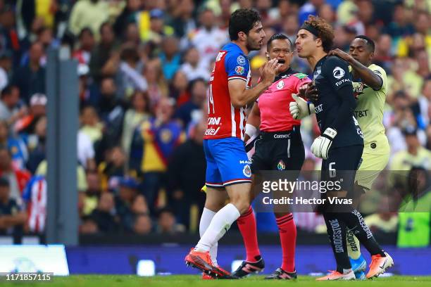 Guillermo Ochoa of America spits to Antonio Briseno of Chivas after a foul against Giovani Dos Santos of America during the 12th round match between...
