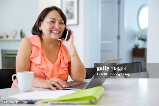 latin american senior woman hearing good news on smart phone - sleeveless top stock pictures, royalty-free photos & images