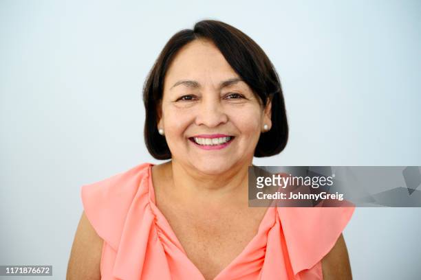 smiling senior hispanic woman - brown hair stock pictures, royalty-free photos & images