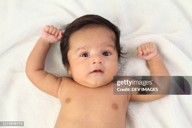 close up of cute baby boy - baby close up bed photos et images de collection