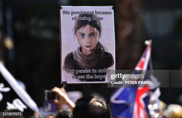 Supporters of Hong Kong pro-democracy protesters gather during a demonstration as part of the global "anti-totalitarianism" movement in Sydney on...