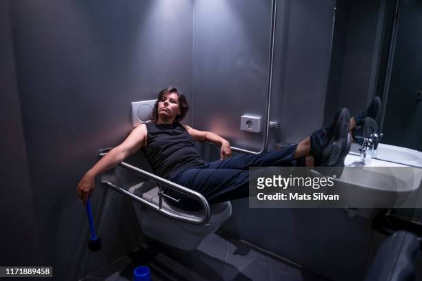 drunk woman sleeping in bathroom - nightclub bathroom stock pictures, royalty-free photos & images