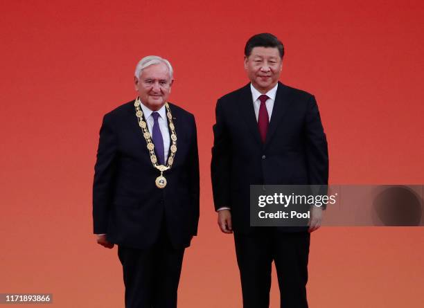 Chinese President Xi Jinping poses for a photo with Former French prime minister Jean-Pierre Raffarin after awarding him a Friendship Medal during a...