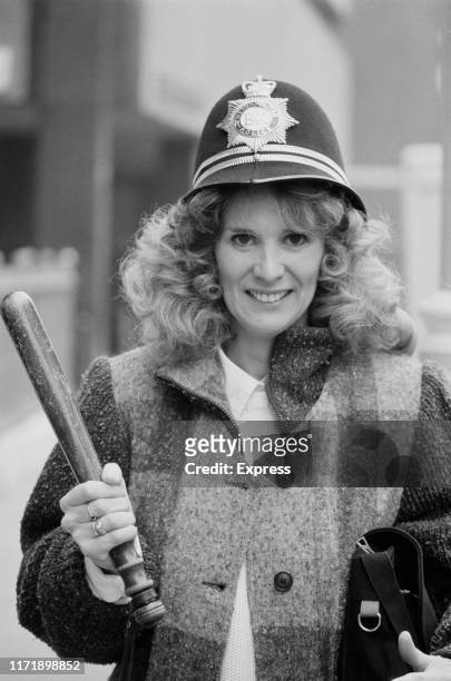 American actress Barbara Bosson mimicking her character 'Fay Furillo' in police drama Hill Street Blues, UK, 12th December 1984.