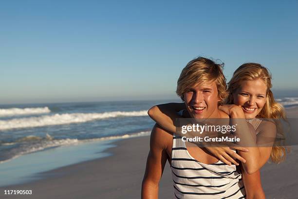 girl and boy on beach - boy and girl love closeness hug beach stock pictures, royalty-free photos & images