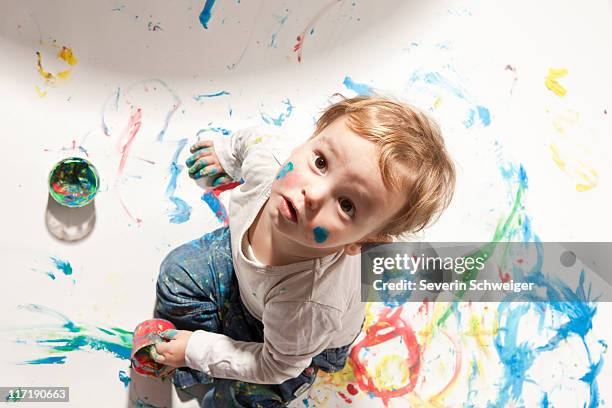 little boy playing with finger paint - baby gender reveal stock pictures, royalty-free photos & images