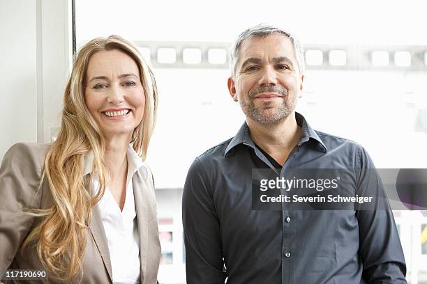 portrait ofmiddle aged man and woman - baby boomer working stock pictures, royalty-free photos & images