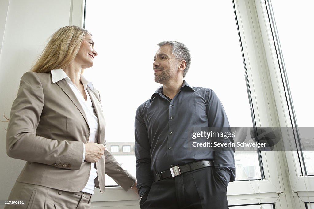 Businesspeople smiling at each other