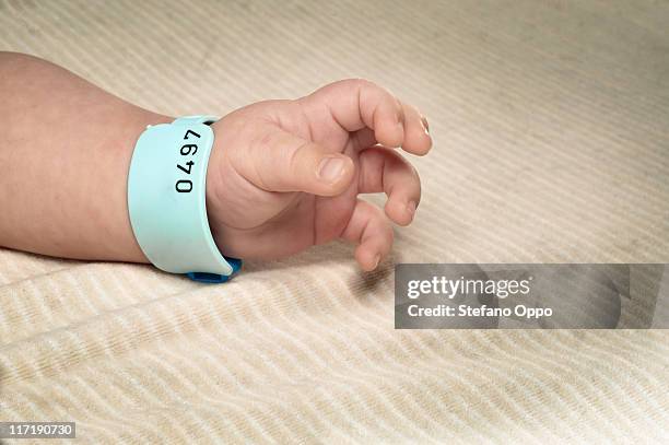 newborn boy with hospital bracelet - baby name stock pictures, royalty-free photos & images