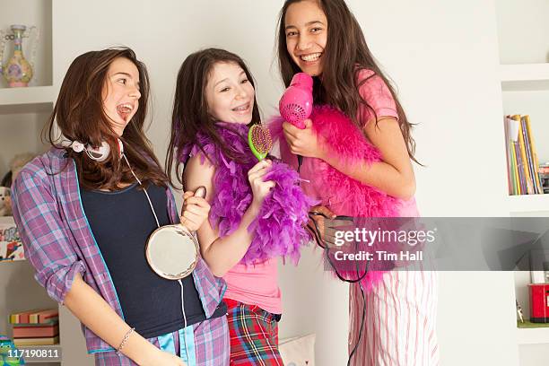 teenage girls singing , wearing pajamas - preteen stock pictures, royalty-free photos & images