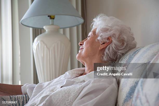 senior woman relaxing on  a sofa - old angelo stock pictures, royalty-free photos & images