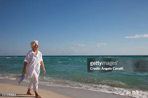 senior woman on the beach - old angelo stock pictures, royalty-free photos & images
