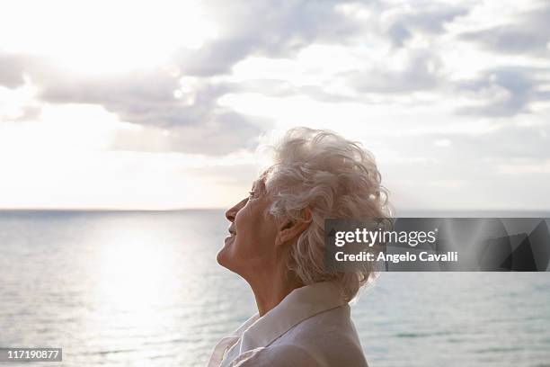 senior woman on the beach - old angelo stock pictures, royalty-free photos & images