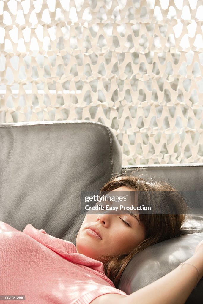 Young woman relaxing on a sofa