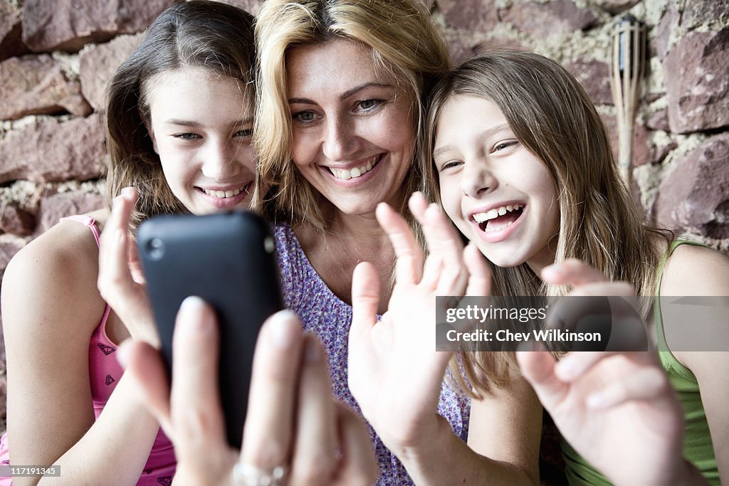 Mother and daughters video call on phone