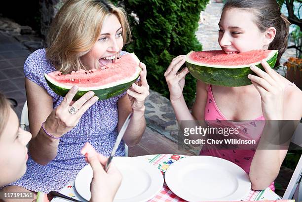 mother and daughter eating watermelon - viewpoint balaton stock pictures, royalty-free photos & images