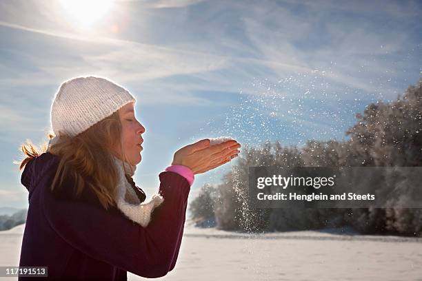 woman blowing snow from hands - healthy lifestyle copy space stock pictures, royalty-free photos & images