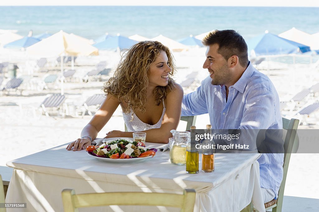 Couple having lunch near the beach