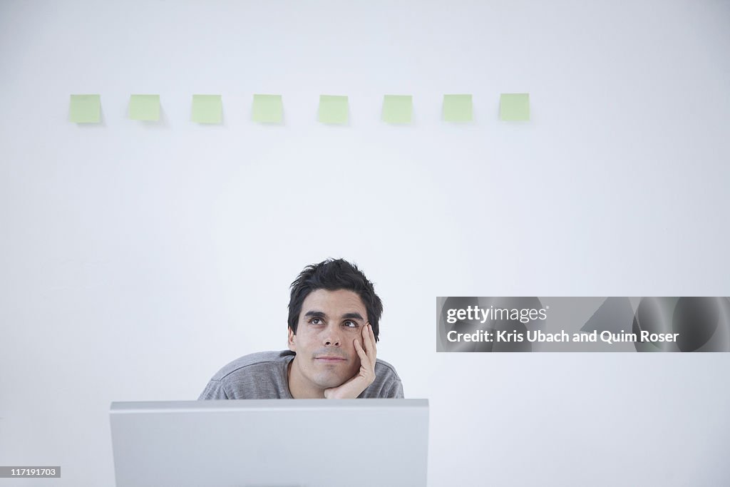 Man thinking at computer