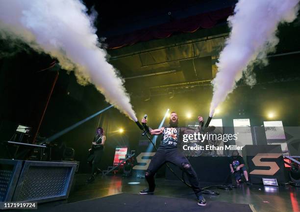 Guitarist/keyboardist Korey Cooper of Skillet performs as singer/bassist John Cooper uses a hand-held C02 blaster cannon during a stop of the...