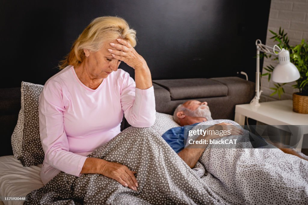 A senior woman has a morning headache