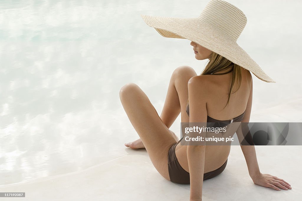 Woman in a swimsuit and large hat