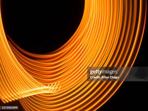 futuristic  curved lines in circular form. it could be production of fusion energy. - nucléus photos et images de collection