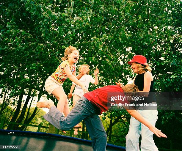 children playing on trampoline - trampoline jump stock pictures, royalty-free photos & images