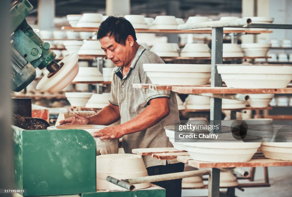 A Senior Staff Polishing Porcelain Clay in Factory