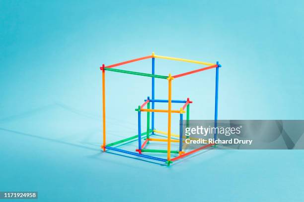 Straws arranged as a small cube inside a large cube
