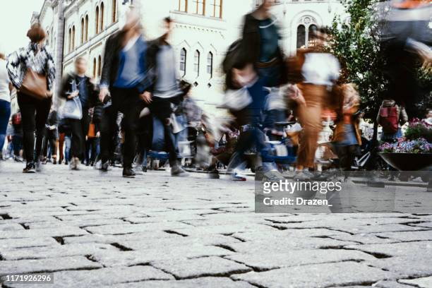 crowded streets and motion blur in city, multi-ethnic large group of people in oslo, norway - on the move stock pictures, royalty-free photos & images