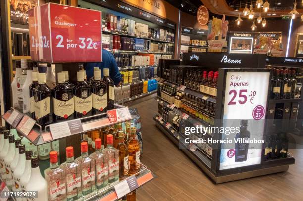 Signs advertise discounts at liquor section of the duty-free area in Humberto Delgado International Airport Terminal 1 on September 02, 2019 in...