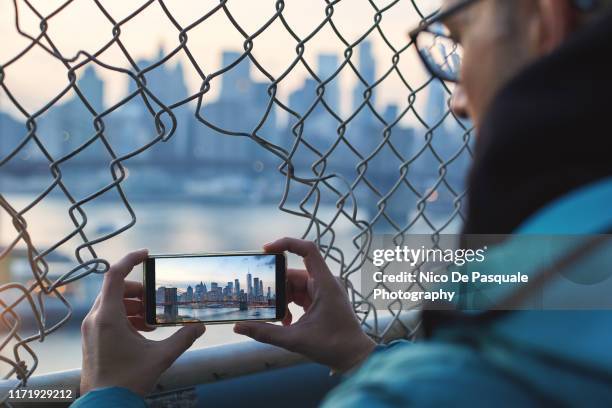 man taking pictures - brooklyn bridge winter stock pictures, royalty-free photos & images