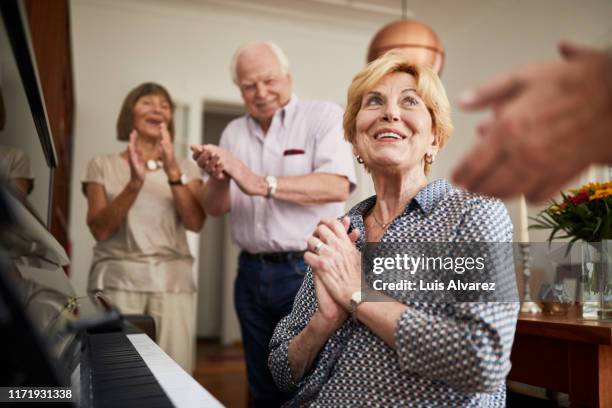 senior people clapping hands for a friend playing piano - pianist vintage stock pictures, royalty-free photos & images