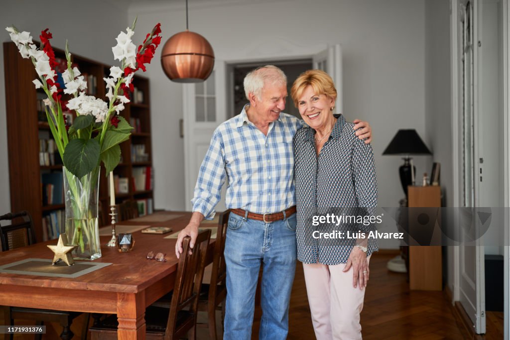 Cheerful retired couple at home