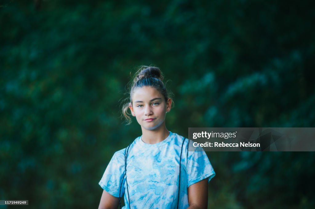 Girl with backpack in forested park