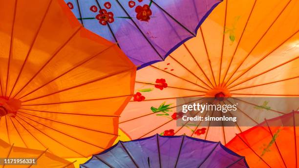 low angle view of colourful umbrella - malaysia pattern stock pictures, royalty-free photos & images