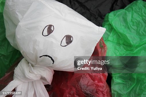 A bunch of disposable, multi-colored plastic bags polluting the environment . Prohibition of the use of plastic bags. A bunch of disposable, multi-colored plastic bags polluting the environment . Prohibition of the use of plastic bags.
