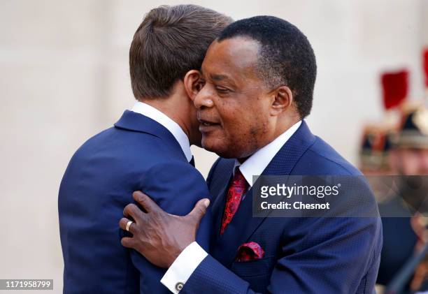 French President Emmanuel Macron welcomes Congolese President Denis Sassou Nguesso prior to their meeting at the Elysee Presidential Palace on...