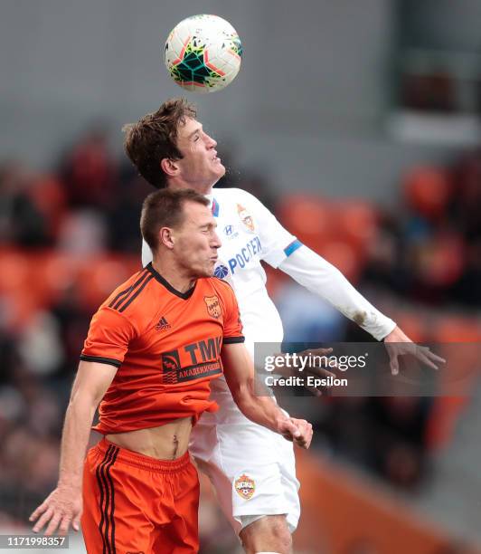 Mikhail Merkulov of FC Ural Yekaterinburg and Mario Fernandes of PFC CSKA Moscow vie for the ball during the Russian Premier League match between FC...