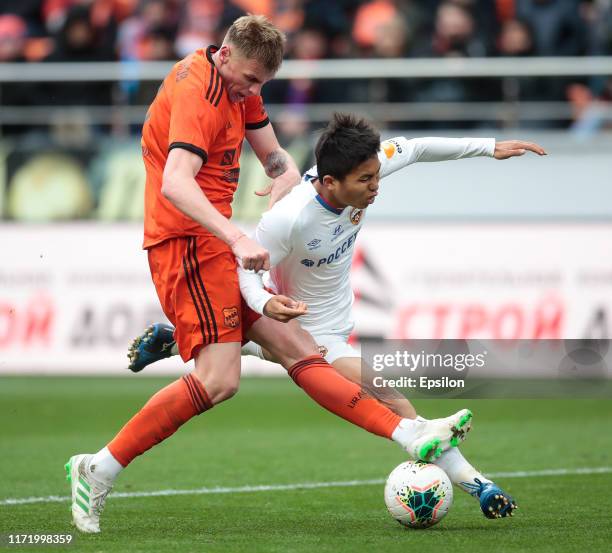 Roman Emelyanov of FC Ural Yekaterinburg and Takuma Nishimura of PFC CSKA Moscow vie for the ball during the Russian Premier League match between FC...