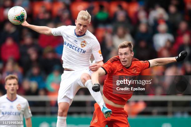 Vladimir Ilyin of FC Ural Yekaterinburg and Hordur Magnusson of PFC CSKA Moscow vie for the ball during the Russian Premier League match between FC...