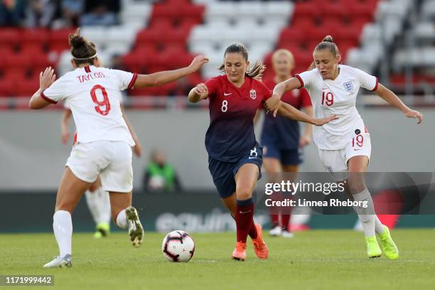 Vilde Boe Risa of Norway battles for possession with Georgia Stanway and Jodie Taylor of England during the International Friendly match between...