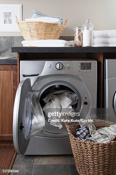 laundry in front load washing machine - laundry basket stock pictures, royalty-free photos & images