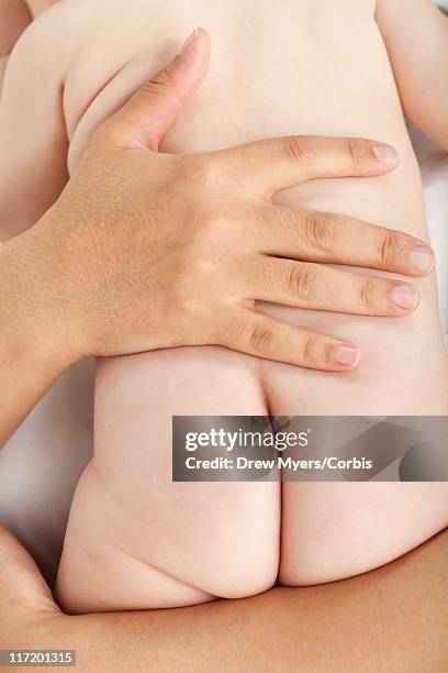 mother holding naked baby - boys bare bum 個照片及圖片檔